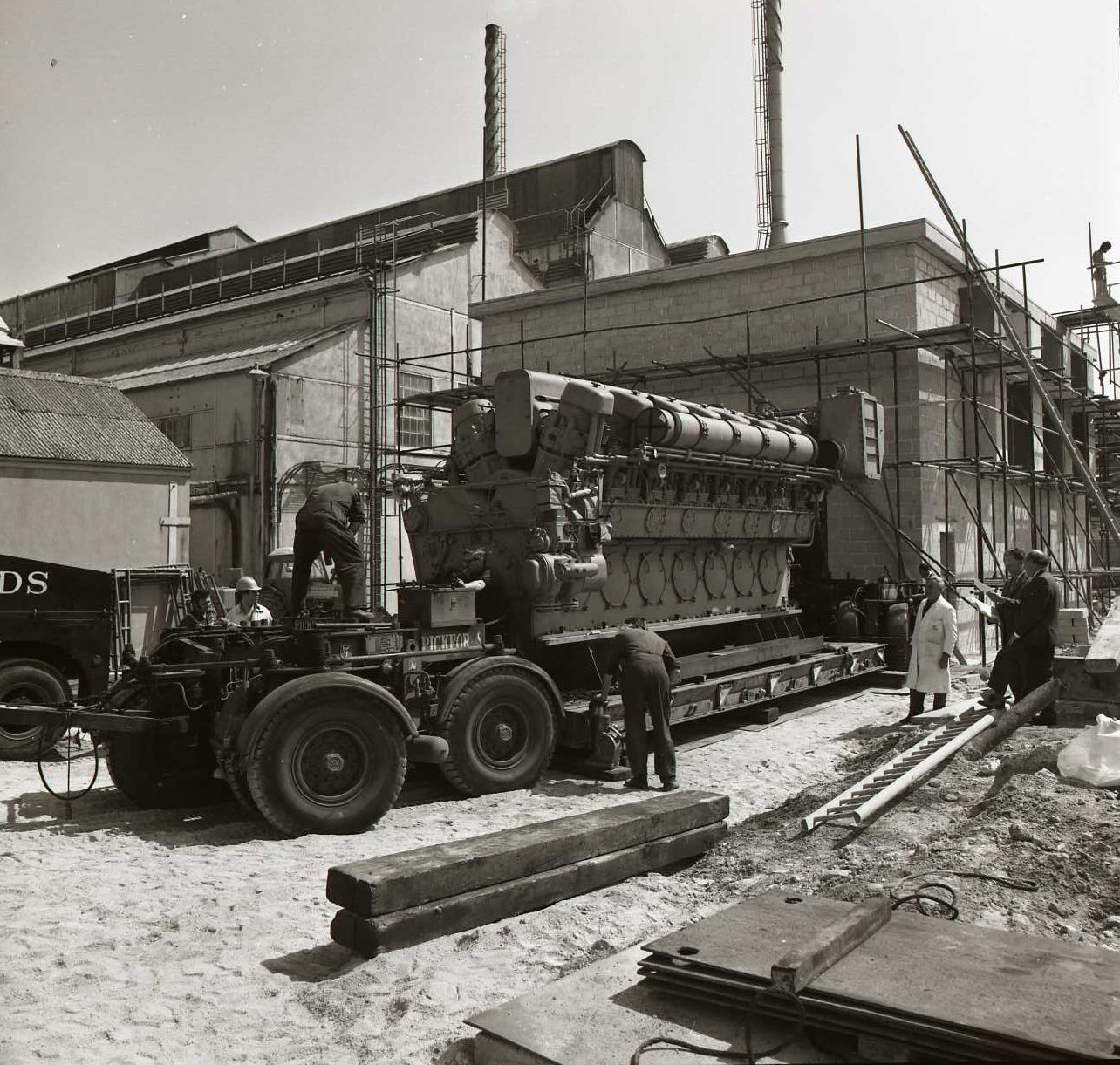 The generator set arrives on Pickfords low-loaders alongside the new engine hall, June 1974.